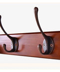 Close-up of Heavy Duty Wall Mounted Coat Hooks Rack with bronze hooks on wooden shelf, perfect for securing coats and hats.