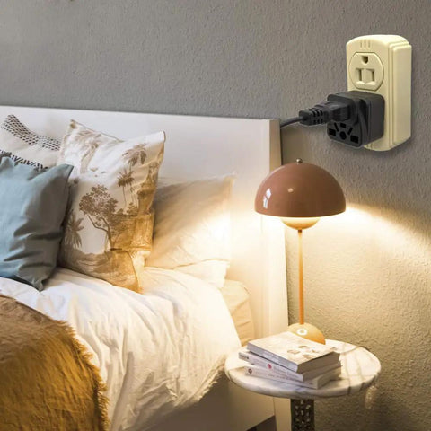 Must Have World Travel Plug Adapter For USA Type B Grounded Outlet in bedroom wall near lamp and bed
