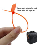 Quick Fix 50 Pack Orange Marker Cable Ties With Blank Labels For Straight Up Wire Grouping slick cord organization being held.