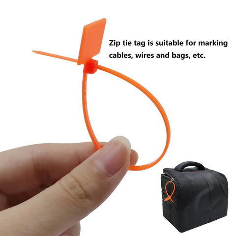 Quick Fix 50 Pack Orange Marker Cable Ties With Blank Labels For Straight Up Wire Grouping slick cord organization being held.