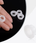 Close-up of white plastic nylon flanged sleeve bearings, 12 Pack Flanged Sleeve Bearings Plastic Bushings Nylon White Bore 10mm By 13mm OD By 6.5mm Length Flange 16.5mm Self Lubricating High Load Nylon Bushings Low Maintenance for DIY Projects and Machinery, shown in hand for size reference.