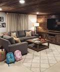 Cozy living room with gray sofa, wooden decor, two backpacks, and rustic styling, featuring Straight Up Premium Aging Wood Stain In Ranchworn.