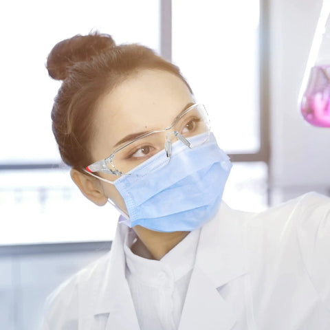 Tough As Nails Clear Safety Glasses Featuring Scratch Resistant Lenses And ANSI Z87 Certification for lab work with vibrant red frames.