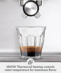 Pro Level Espresso Machine With A Rock Solid Steam Wand For Silky Microfoam And Volumetric Shot Control In Heavy Duty Brushed Stainless Steel Frame pulling a shot of espresso into a glass.