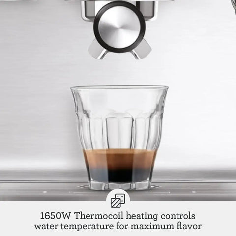 Pro Level Espresso Machine With A Rock Solid Steam Wand For Silky Microfoam And Volumetric Shot Control In Heavy Duty Brushed Stainless Steel Frame pulling a shot of espresso into a glass.