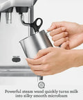 Dual Boiler Espresso Machine in Brushed Stainless Steel Featuring 58mm Commercial Portafilter and Precision Temp Control for Killer Shots and Legit Barista Quality Coffee at Home with steam wand and milk jug.