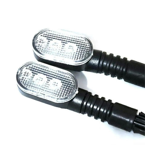 Upgrade Your Ride With This Epic Ebike Tail Light Featuring Bright Led Turn Signals And Wide Voltage Support For 36v To 72V Battery Systems Ensuring You Stay Safe On Night Rides Or In Bad Weather While Looking Awesome. Pair of oval ABS ebike tail lights with clear LED lenses and black cable stems, 59mm by 33mm