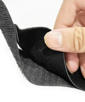 Close-up of hand holding Heavy Duty Car Trunk Organizer Straps with hook and loop tape and reinforced nylon webbing.