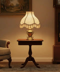 Beige Transitional Scallop Bell Lamp Shade With Spider Construction on table, enhancing living room with warm, classic glow