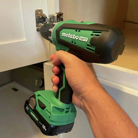 Person using Go-To 18V Cordless Drill Driver Kit With 1/2-Inch Keyless Chuck on cabinet hinge