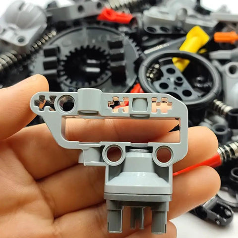 Close-up of parts from Technical Car Suspension Building Kit With 144 Pieces Including Wheels Connectors Shock Absorbers Turntable