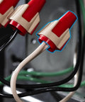 Close-up of Twister Pro Wire Connectors in use with red SureGrip overmold, demonstrating easy connection with wires.
