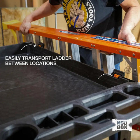 MODBox Utility Cart Ladder Holder and Storage Hooks for Secure Vertical or Horizontal Ladder Mounting on MODBox Carts Heavy Duty Easy Access Keeps Ladders Ready to Roll, showing a worker installing a ladder on the cart.