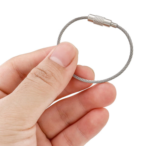 Hand holding Stainless Steel Wire Key Ring Cables 25 Pack, 4.6 Inch Loops For Travel Luggage Tags, Keys, Dog Tags, and Hanging Key Rings
