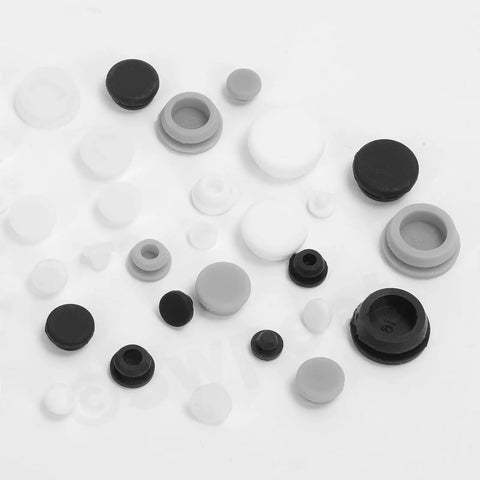 Massive Set Of 120 White Rubber Plugs In 9 Sizes For Round Holes, Heavy Duty Silicone Snap Locking Stopper Kit Perfect For Furniture Repair And DIY Projects Around The House. Assorted white and black silicone hole plugs in multiple sizes on white background.