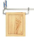 Slick Auto Adjust Bar Clamp For Woodworking And Diy Assembly Self Adjusting One Hand Press Tool on a wooden frame.