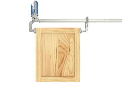 Slick Auto Adjust Bar Clamp For Woodworking And Diy Assembly Self Adjusting One Hand Press Tool on a wooden frame.