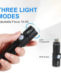 Hand holding USB chargeable flashlight with three light modes, adjustable focus, and shift knob.