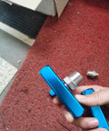 Hand holding Beefy 3 Way 1/2 Inch Manifold Block Splitter For Air Hose Inline Fittings, silver blue finish, iron build