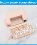 Bottom view of a pink heavy duty hole punch with detachable scrap tray and paper confetti, part of a two-piece metal set for crafts.