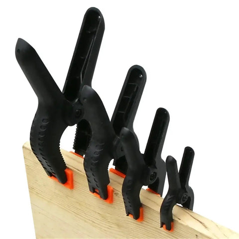 Handy Nylon Spring Clamps Set For DIY Woodworking 2 3 4 6 Inch Clips affixed on a wooden board showcasing secure grip