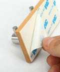 Heavy Duty Rustic Wall Hooks Featuring Sturdy Metal Claws Zero Drill Hassle Super Easy Peel And Stick Mount shown with adhesive backing removal.