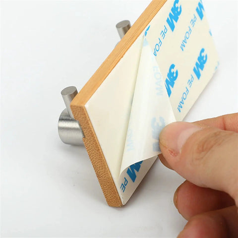 Heavy Duty Rustic Wall Hooks Featuring Sturdy Metal Claws Zero Drill Hassle Super Easy Peel And Stick Mount shown with adhesive backing removal.