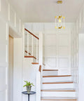 Gold Pendant Light Fixture With Brushed Brass Finish, 1 Light Modern Linear Chandelier in stairway with white paneled walls