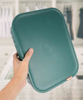 Hand holding a Heavy Duty Underwear Storage Box With Secure Lid, durable plastic organizer for socks and sleepwear.