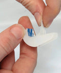 Person peeling adhesive backing from Self Adhesive Drawer Bumper Translucent 10 Pack for Cabinets and Rollout Shelves Protects Doors From Marring