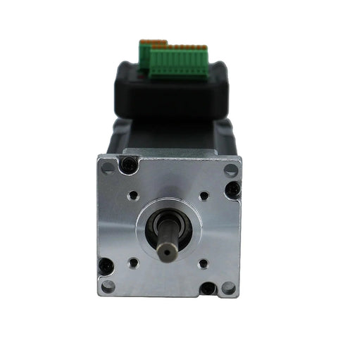 NEMA 23 integrated stepper motor with driver module, silver front face with shaft and green terminal block at rear.
