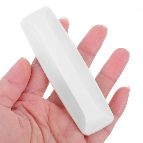 Top Grade No Hassle Self Adhesive Cabinet Handles Pair White Pp Drawer Knobs held in hand showing smooth design and size.