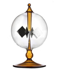 Orange Solar Powered Crookes Radiometer Glass Windmill Desk Ornament Sun Driven Spinning Vane Decor For Home Office Vacuum Glass Bulb Science Gift That Whirls Faster In Bright Light A Cool Modern Conversation Starter showing clear glass bulb and spinning vanes.