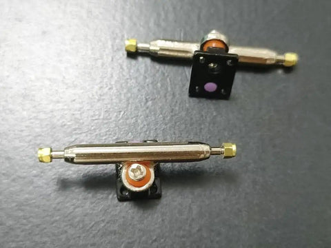 10 Sets Pro Fingerboard Truck Bushings Orange And White PU Material Fits All Pro Fingerboard Trucks Random Colors Durable And Stiffer Than Standard Bushings For Dope Smooth Turns And Precise Grips, showing bushings attached to pro trucks.