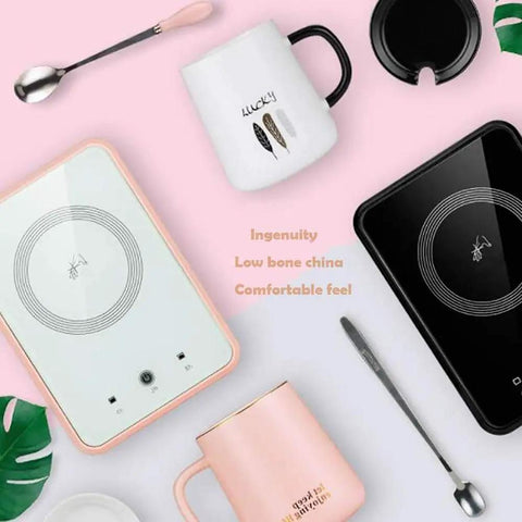 Keep That Coffee Strong Desk Cup Warmer With Steady 55 Degree Thermostat Handles Your Daily Grind Like A Boss Black Beverage Heating Pad And Matched Travel Mug on a pink background with mugs and utensils.