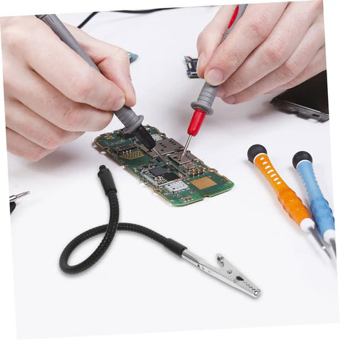 Person using Five Piece Third Hand Soldering Tool Set with Flexible Gooseneck Arm for PCB repair and electronics welding.