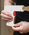 Automotive Spot Welding Torch For Cars, shown in hand, compact white and red, precise tool for dent repair and metal restoration