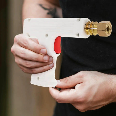 Automotive Spot Welding Torch For Cars, shown in hand, compact white and red, precise tool for dent repair and metal restoration
