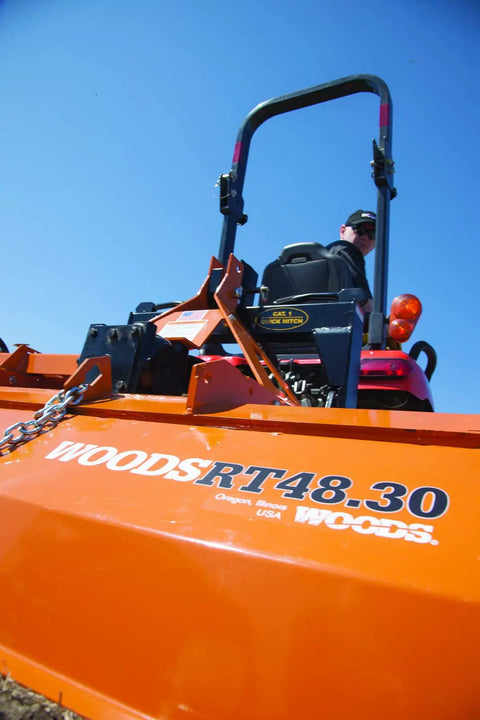 Close-up of Woods RT48.30 rotary tiller with operator, compatible with Left Hand Speed Blade OEM Replacement For RT60.40 Rotary Tiller.
