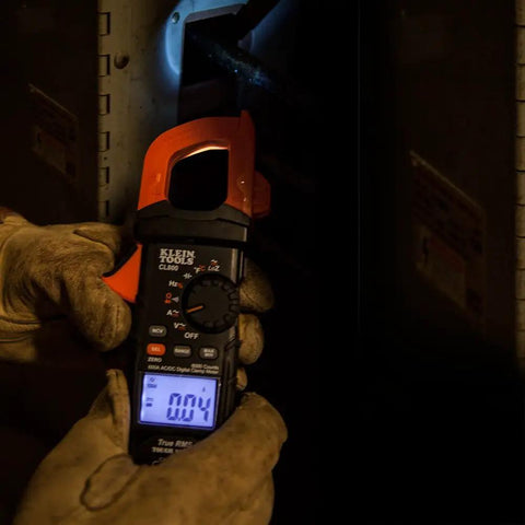 Electrician using Digital Clamp Meter With Auto Ranging TRMS, Measures AC DC Voltage And Current, LoZ Ghost Voltage in panel