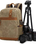 Waterproof Camera Backpack With Hidden Side Access, Retro Batik Canvas DSLR Shoulder Bag next to camera and tripod gear