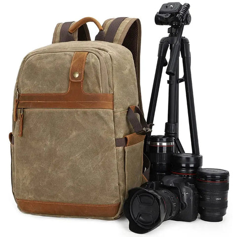 Waterproof Camera Backpack With Hidden Side Access, Retro Batik Canvas DSLR Shoulder Bag next to camera and tripod gear