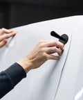 Hands using 9 In 1 Vinyl Wrap Tools Kit With Heat Gun For Car Wrapping And Window Tinting Includes Squeegees, Magnet Holder.