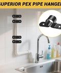 Front view of four black nylon 1/2-inch PEX pipe hangers clamped to a vertical pipe under a kitchen sink.