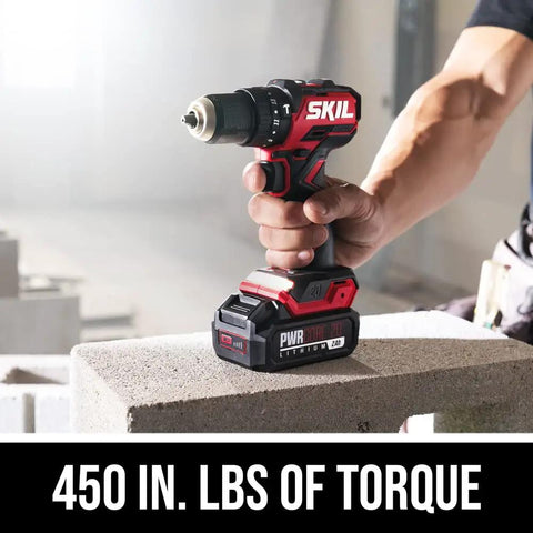 Person using Power Core 20 Brushless 20V Compact Three In One Hammer Drill Kit With One Half Inch Keyless Chuck on concrete block