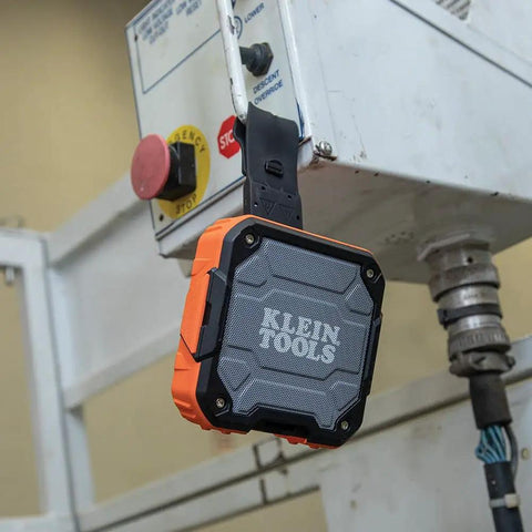 Rugged Bluetooth Speaker With Magnetic Strip And Hook, Rechargeable, attached to industrial equipment, showcasing durability for jobsites.
