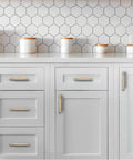 10 Pack 5 Inch Center Hole Champagne Bronze And Honey Bronze Cabinet Pulls installed on white kitchen cabinets.