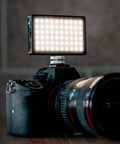 Pocket Sized Pro Grade Bicolor Panel Mini LED Light for DSLRs attached to camera showing adjustable panel and LCD display