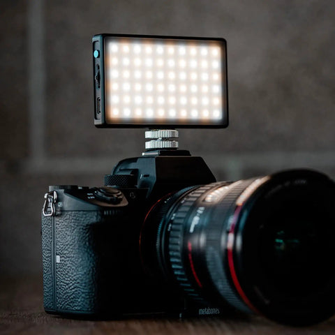 Pocket Sized Pro Grade Bicolor Panel Mini LED Light for DSLRs attached to camera showing adjustable panel and LCD display