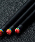 Premium Carbon Fiber Pool Cue Stick With Maple Technology Shaft And 11.5 Millimeter Tip showing tips on black leather background.